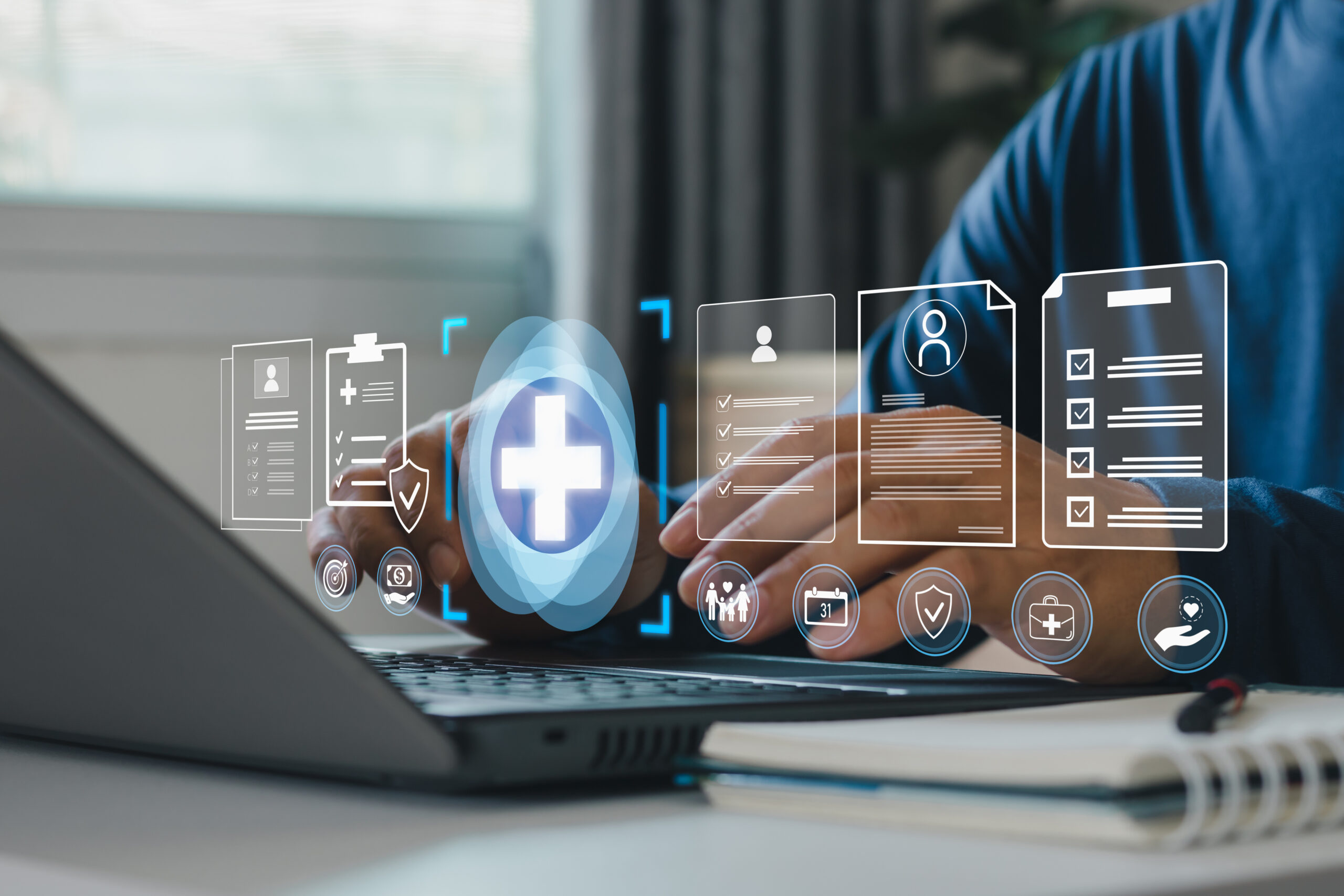 Person typing on laptop with health data icons